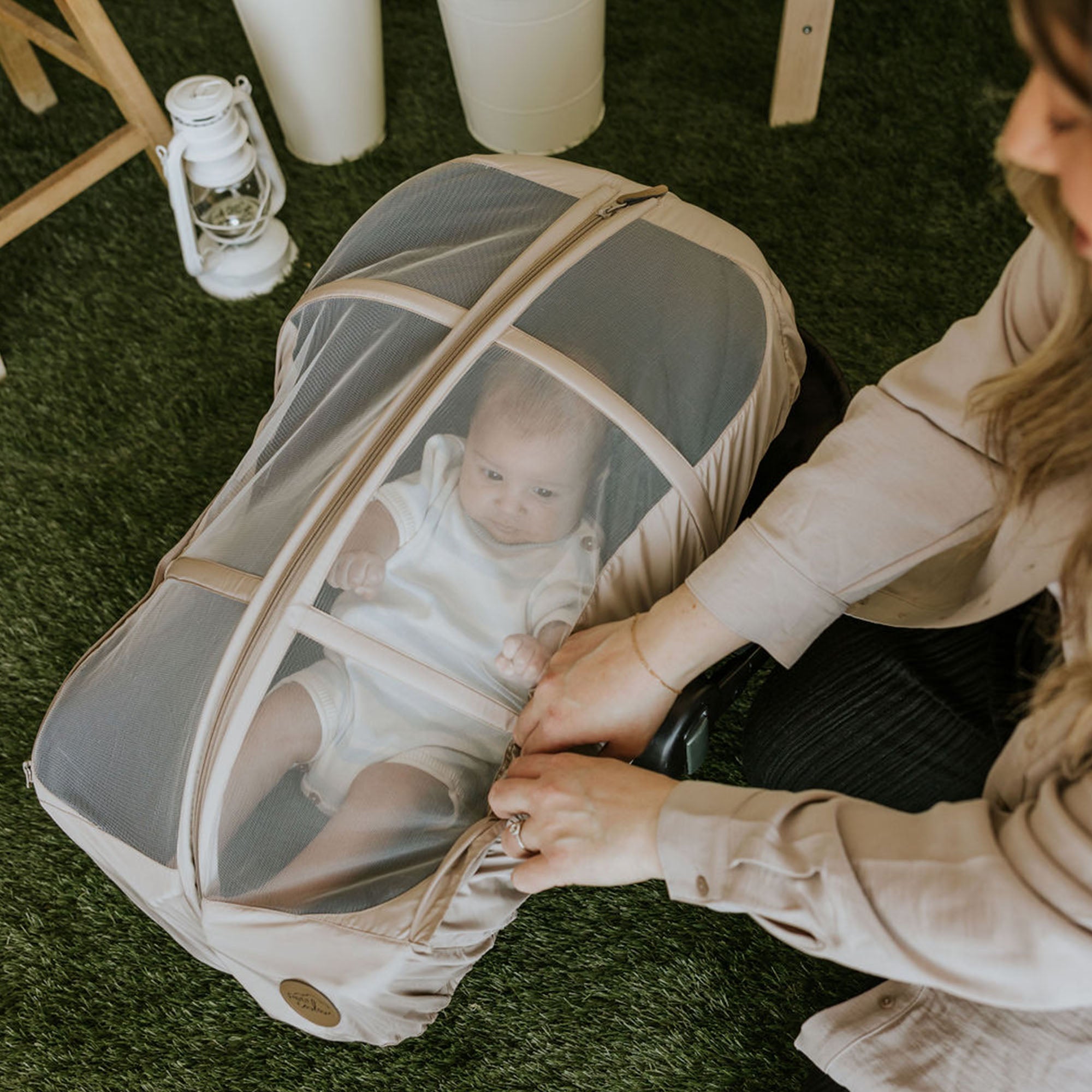 Baby in his car seat with a Petit Coulou summer car seat cover on it - It protects baby from mosquitoes, sun and wind.