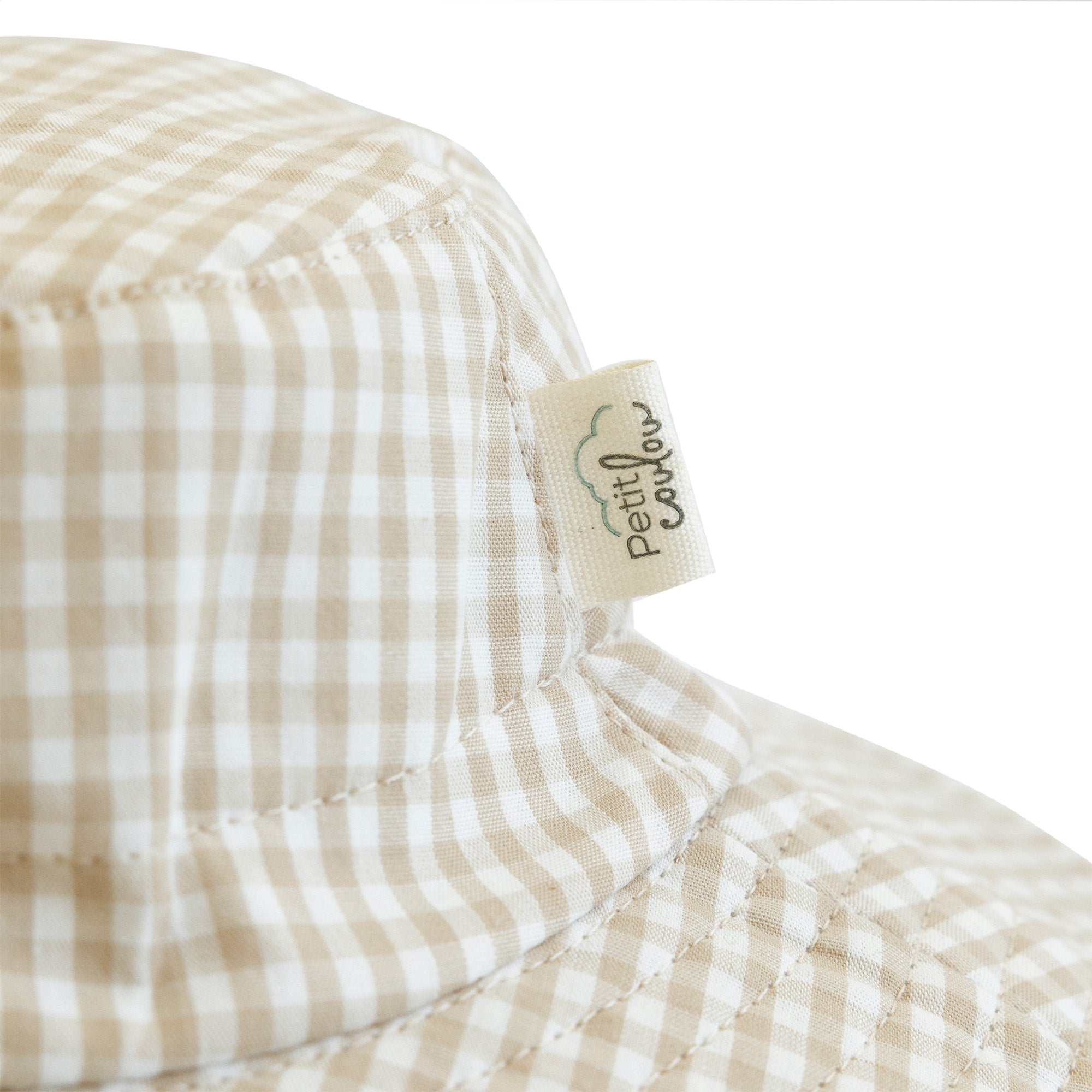 Close up of Petit Coulou logo on a sun hat for baby